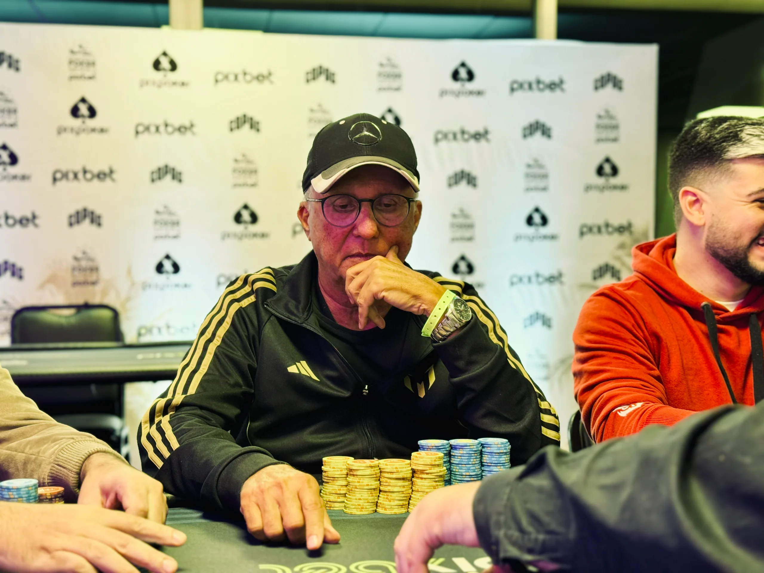 Vladimir Guimarães looking at his poker chips at a tournament table
