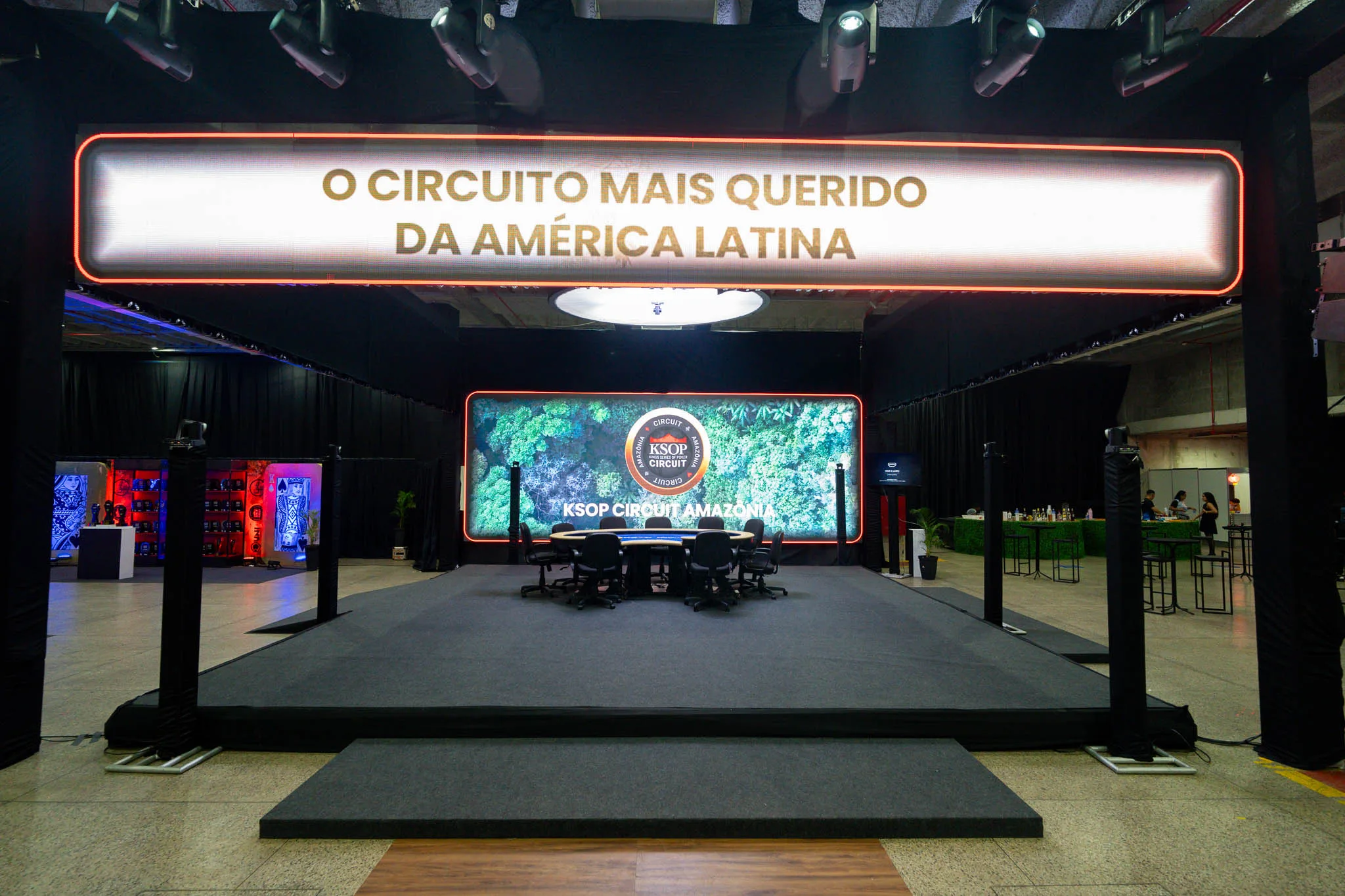 Poker players at a tournament table with cards and chips during the KSOP Circuit Amazônia event