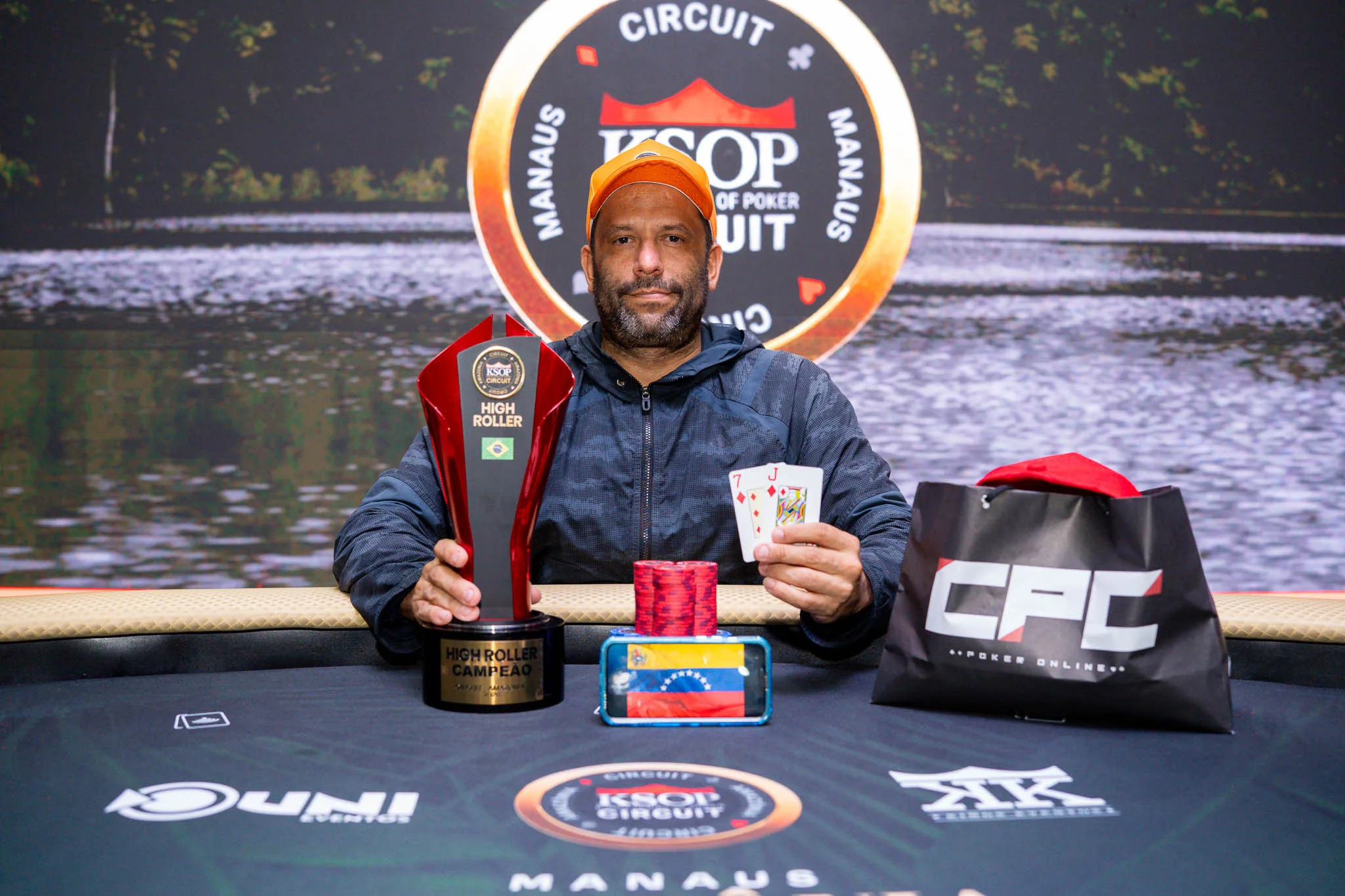 Poker players at a high-stakes tournament table with cards and chips