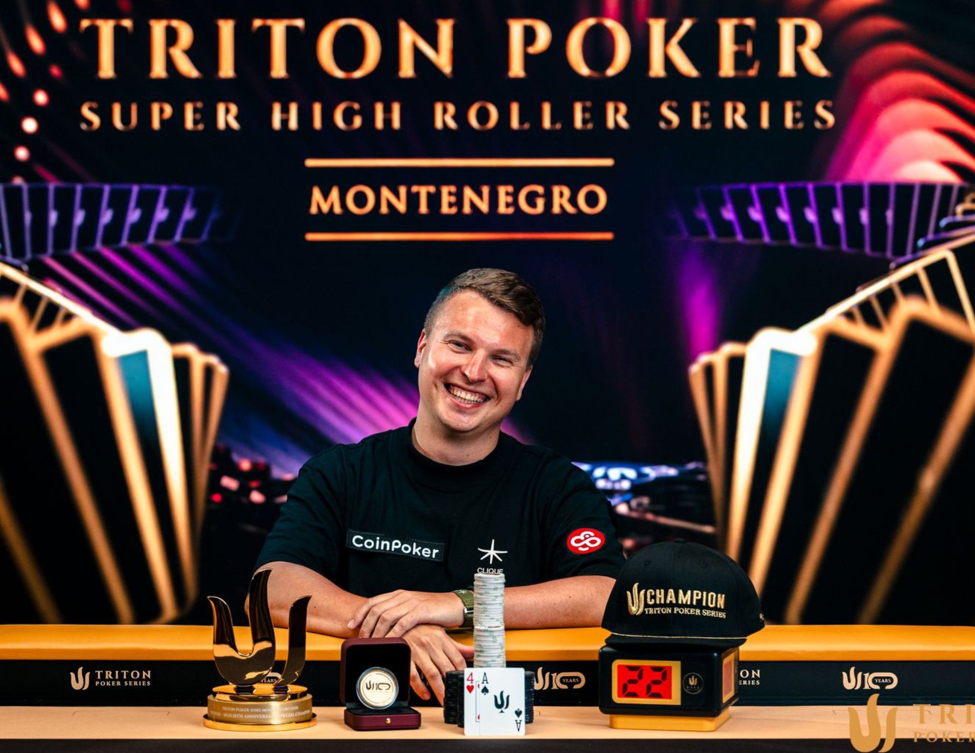 Aleks Ponakovs holding the Triton Poker trophy after winning the championship event.