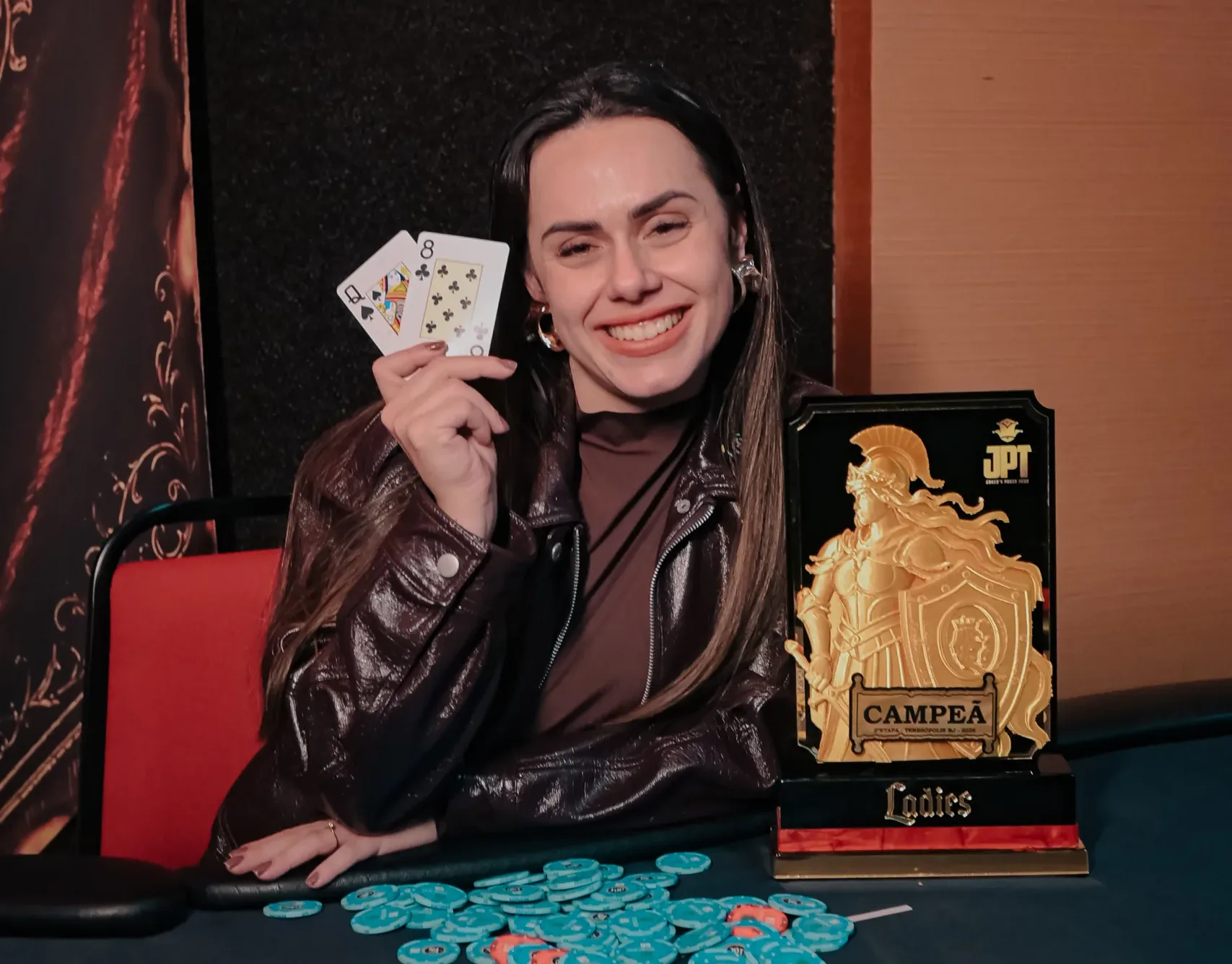 Raysa Santos, winner of the JPT Ladies event, smiles with her trophy.