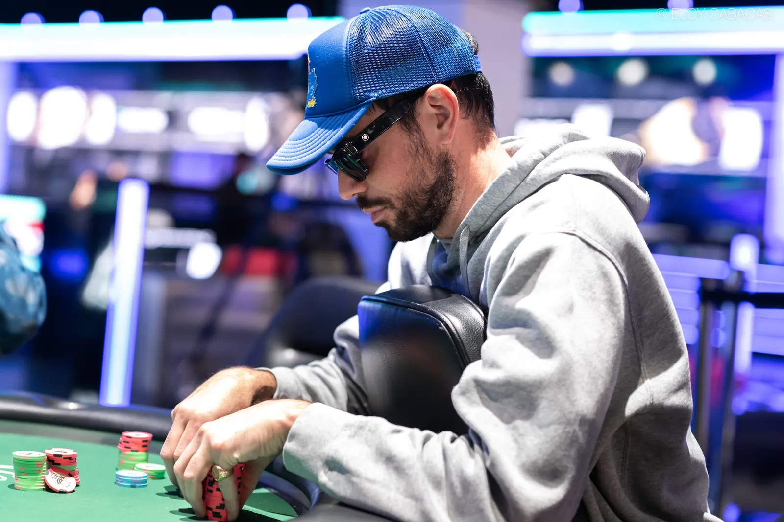 Nick Schulman, a Poker Hall of Famer, is seen at a World Series of Poker final table, concentrating on the game.