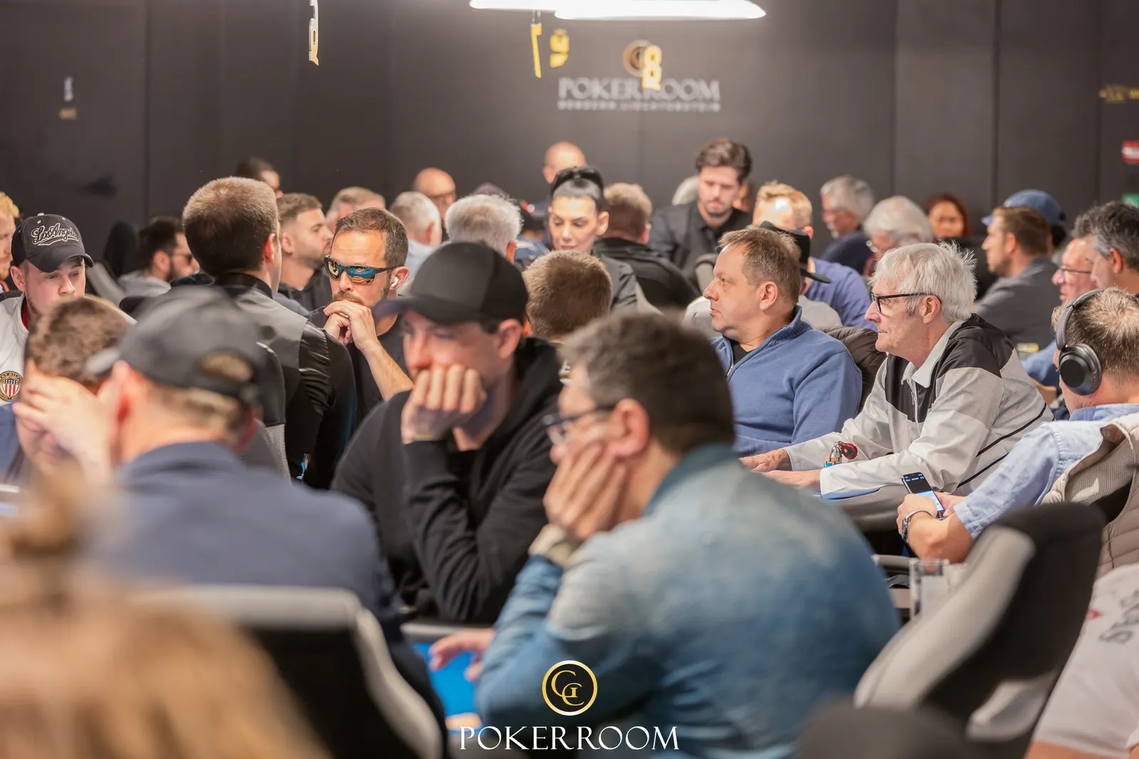 A poker table at the Grand Casino Liechtenstein with players engaged in a game.