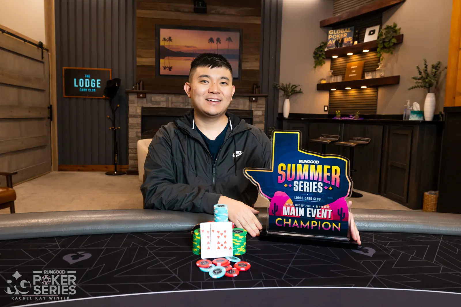 Poker player Bohuai Jiang holding up a trophy after winning a tournament.