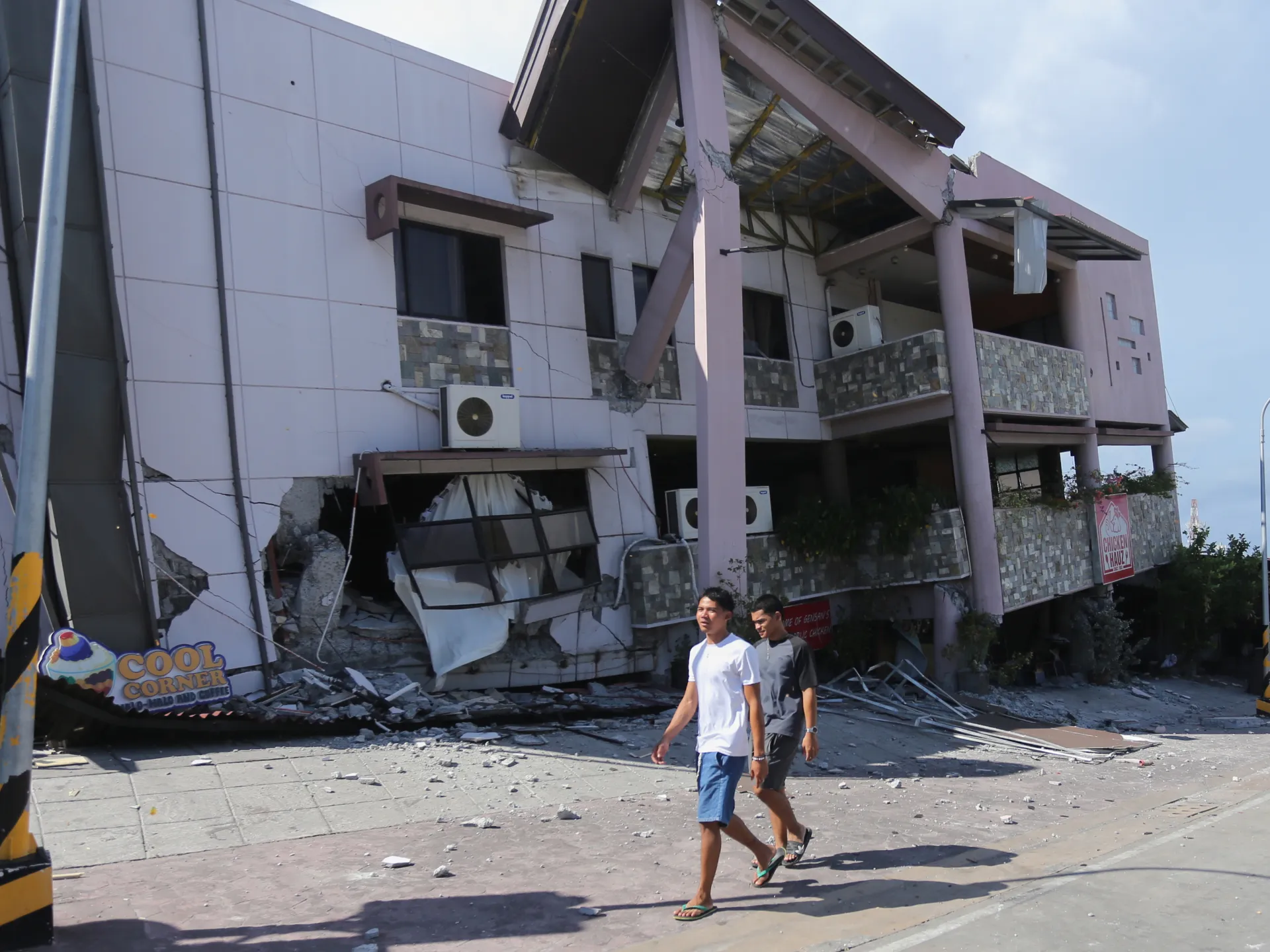 Rescue workers carefully search through debris following a significant earthquake in the Philippines.