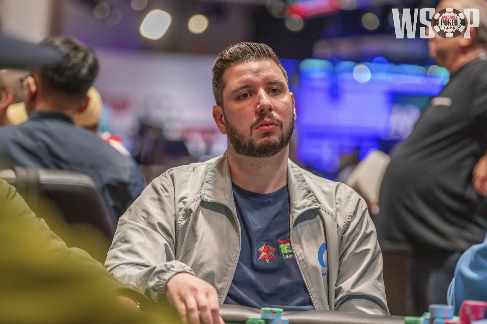 A poker player at a tournament table, representing Leonardo Camera's WSOP final table appearance.
