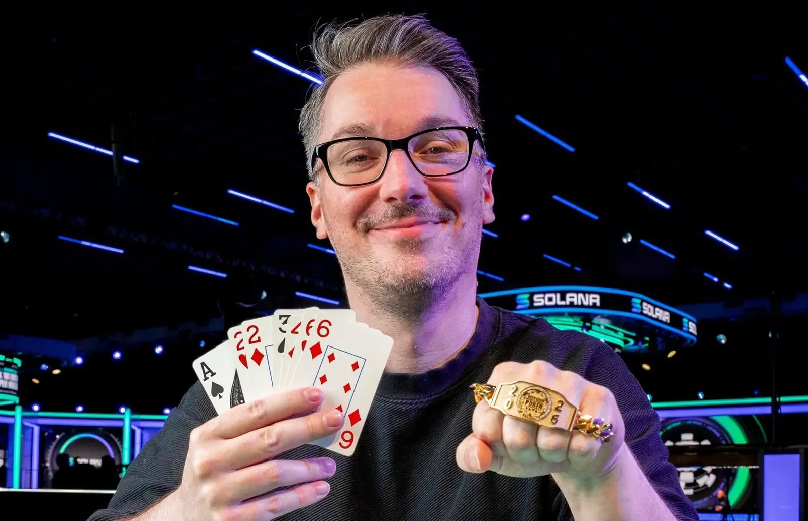 Sebastian Pauli, winner of the WSOP $1,500 Razz event, holding his gold bracelet.