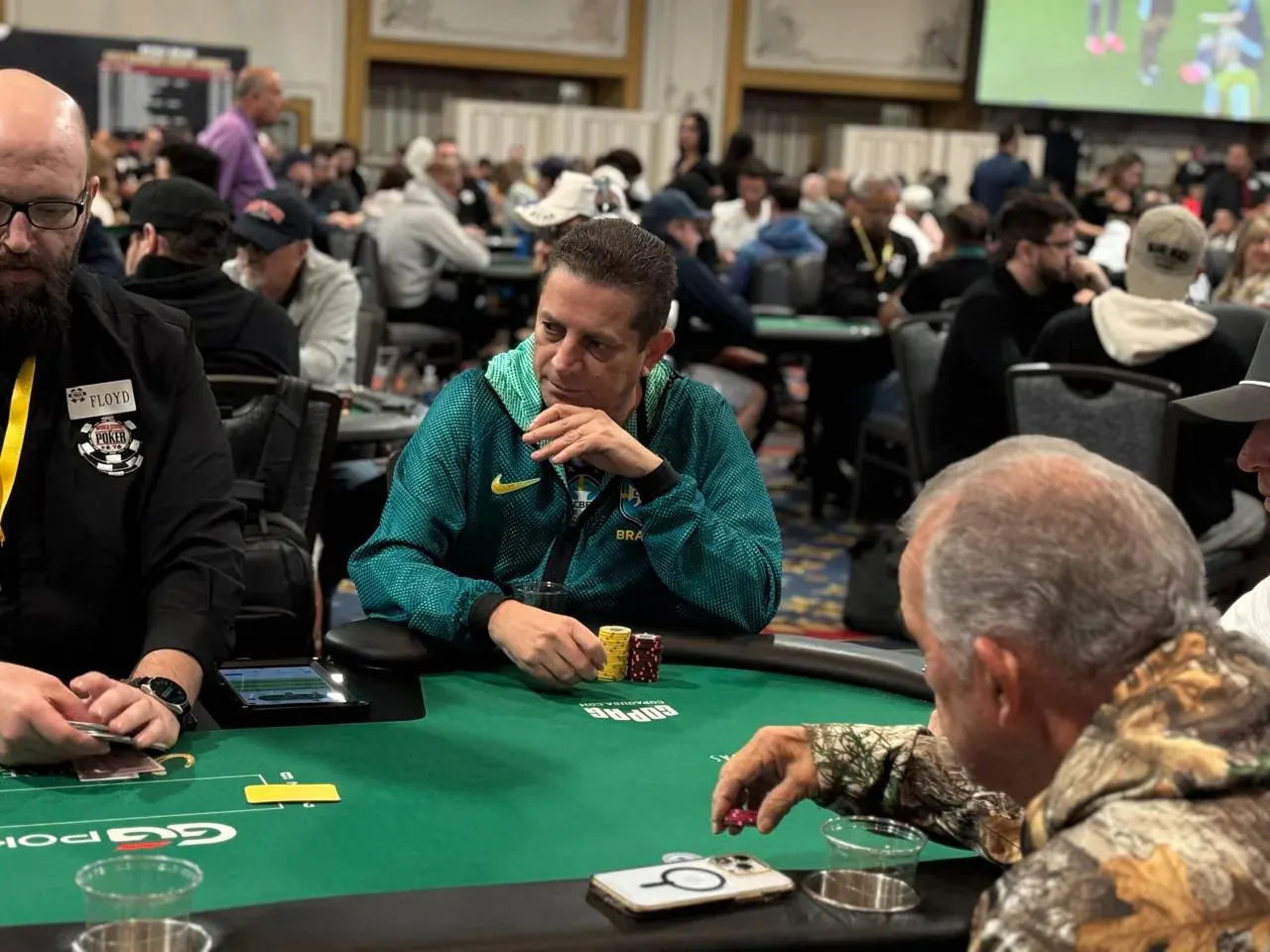 Players seated at a poker table during a World Series of Poker tournament.