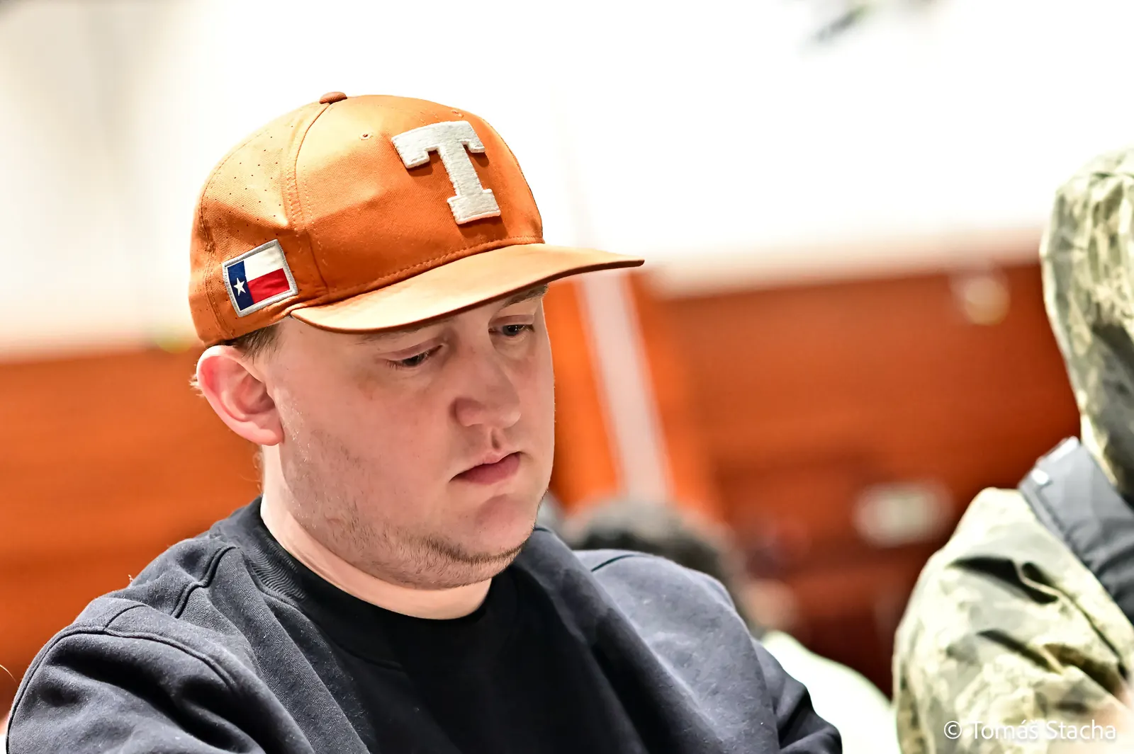 A high-stakes poker player, identified as "Texas Mike," at a poker table during a live-streamed game.