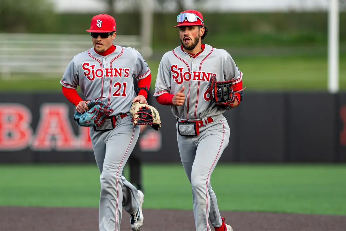 Baseball players on a field during a college baseball game.