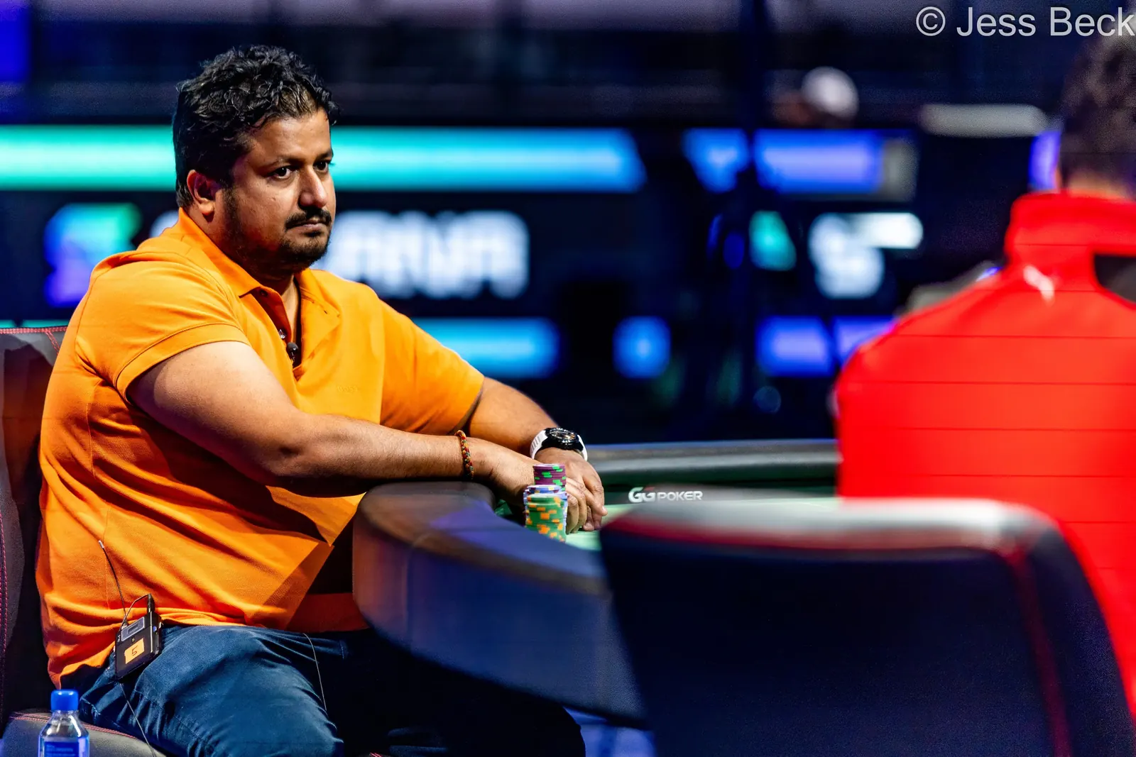 Santhosh Suvarna holding a poker tournament trophy and smiling