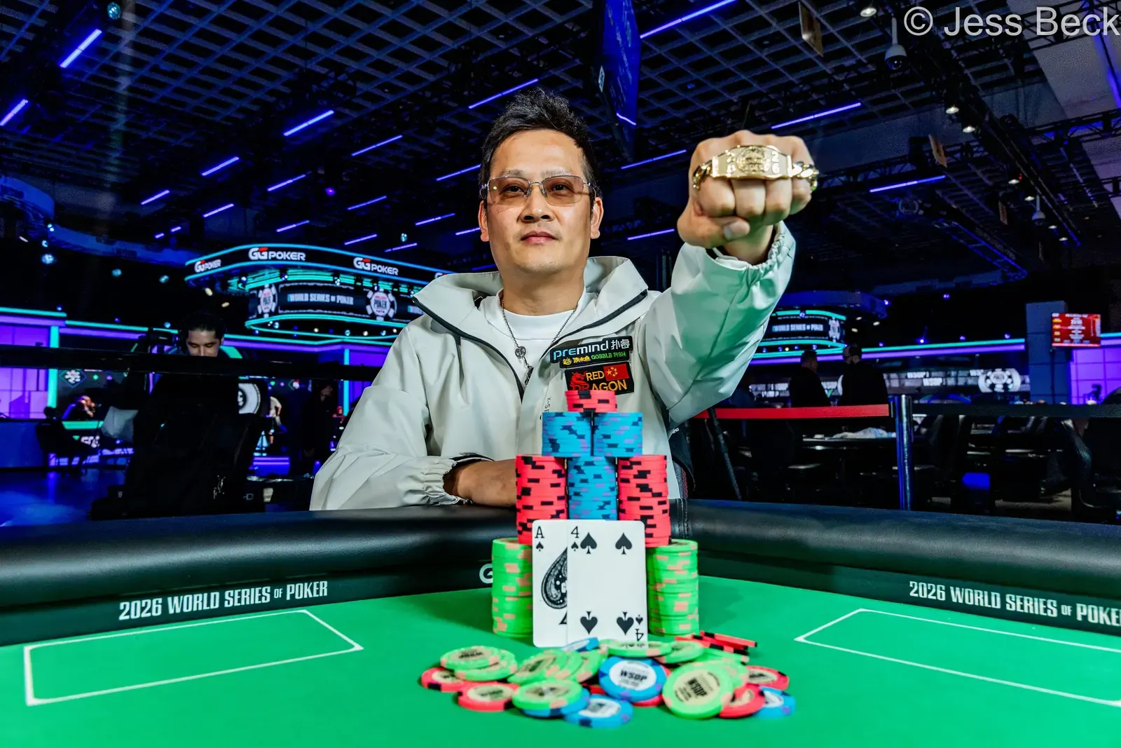 Dong Chen holding his WSOP gold bracelet after winning the $10,000 Limit Hold'em Championship.
