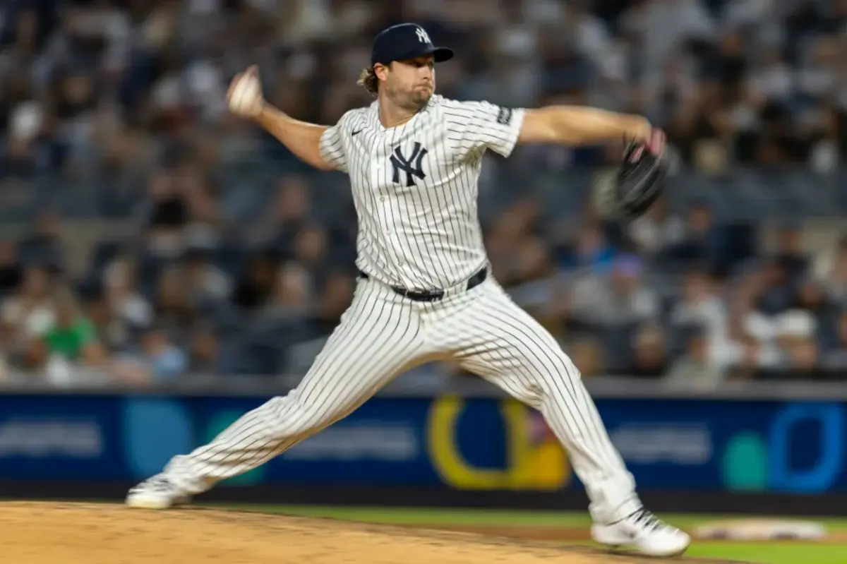 A New York Yankees starting pitcher in the middle of a throw during a baseball game.