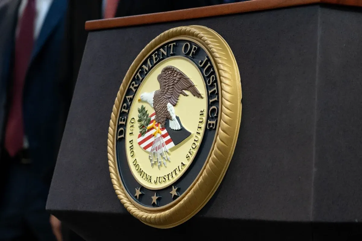Image of the Department of Justice building or a gavel on a legal book.