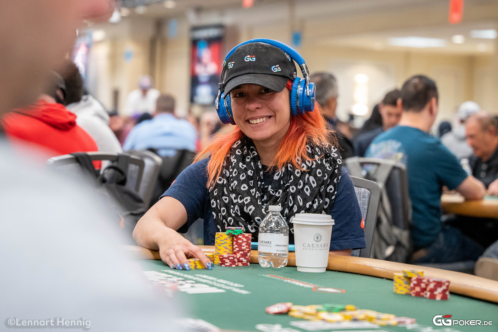 A poker player at a final table, focused on the game.