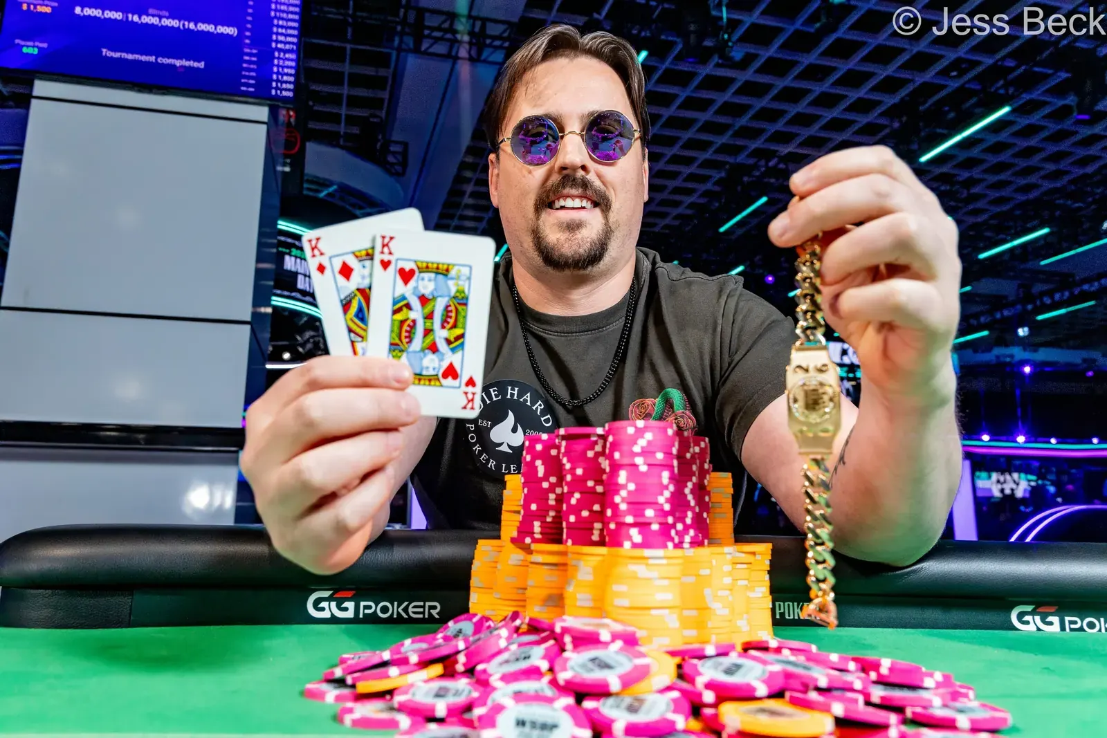 Eric Weber, winner of the WSOP $600 Ultra Stack event, holds his bracelet and smiles.