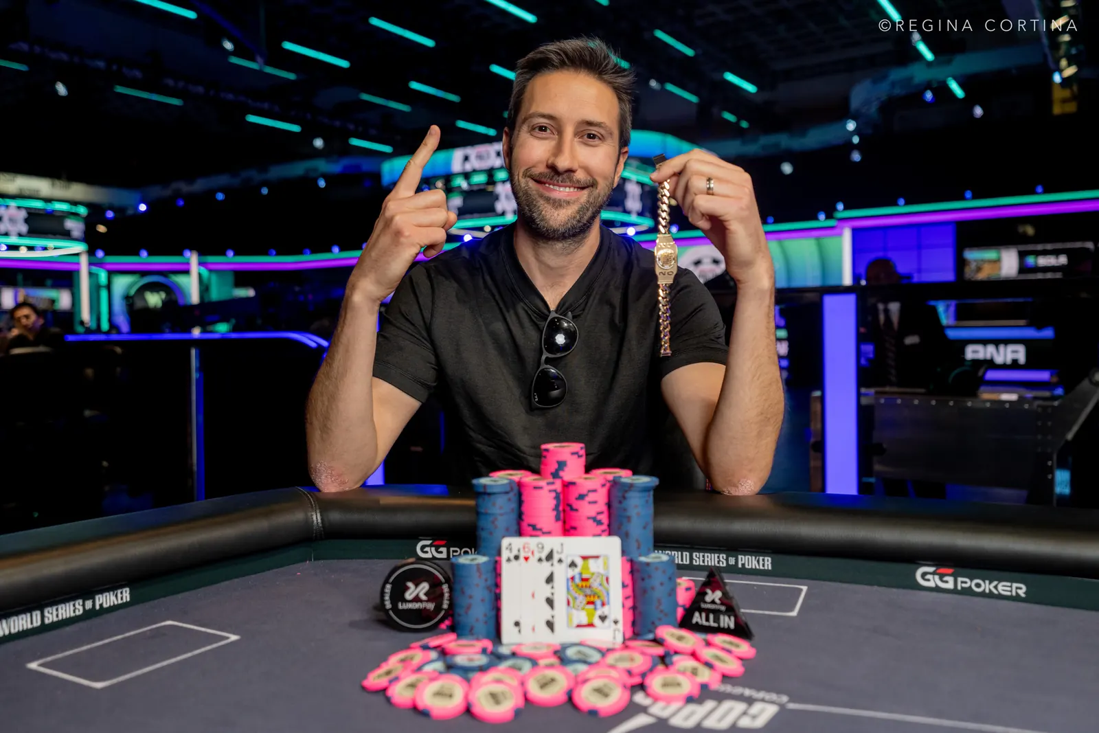 Matthew Shepsky smiling and holding a World Series of Poker bracelet.