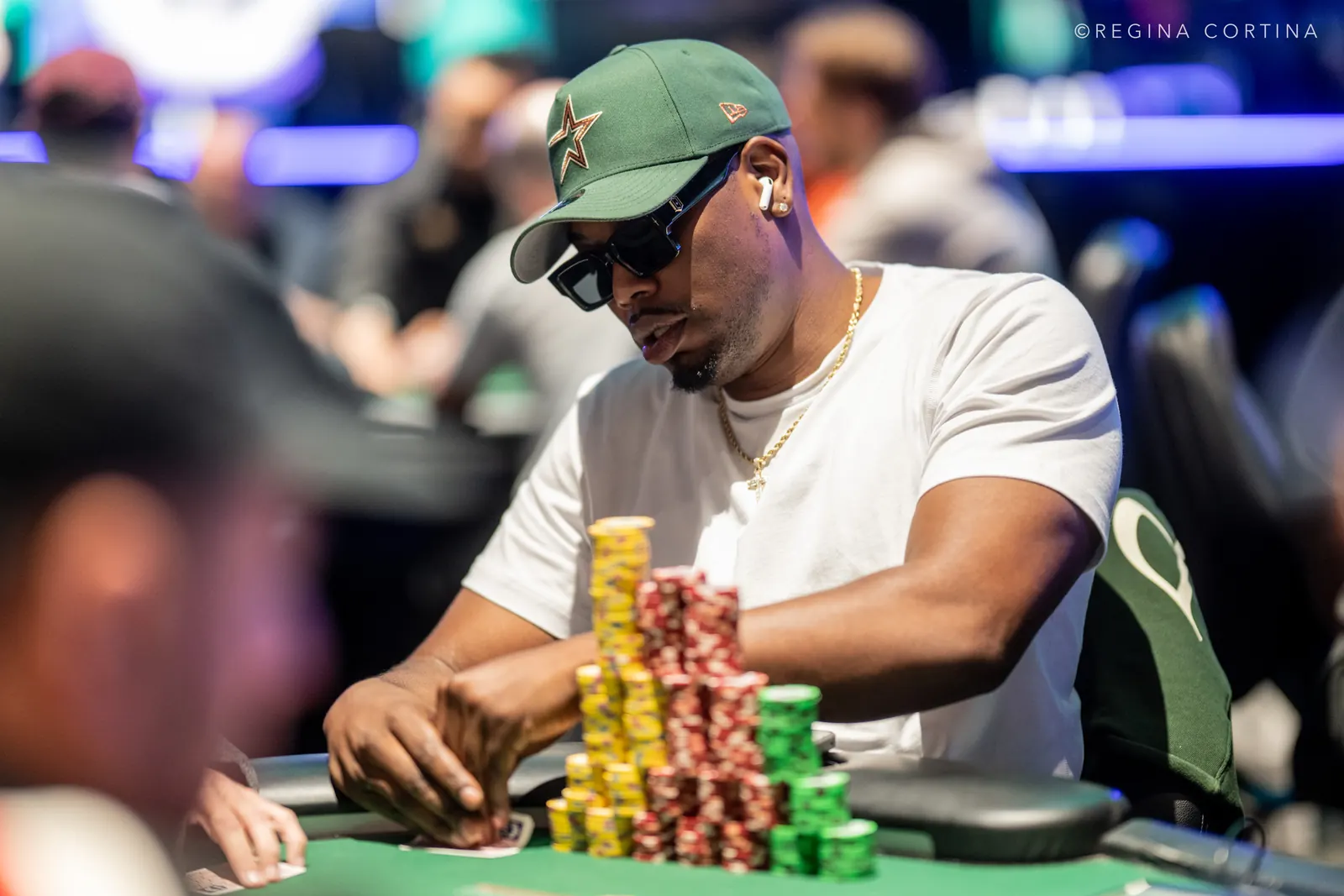 Will Givens, a poker player, sits at a table during the World Series of Poker Main Event, looking focused.
