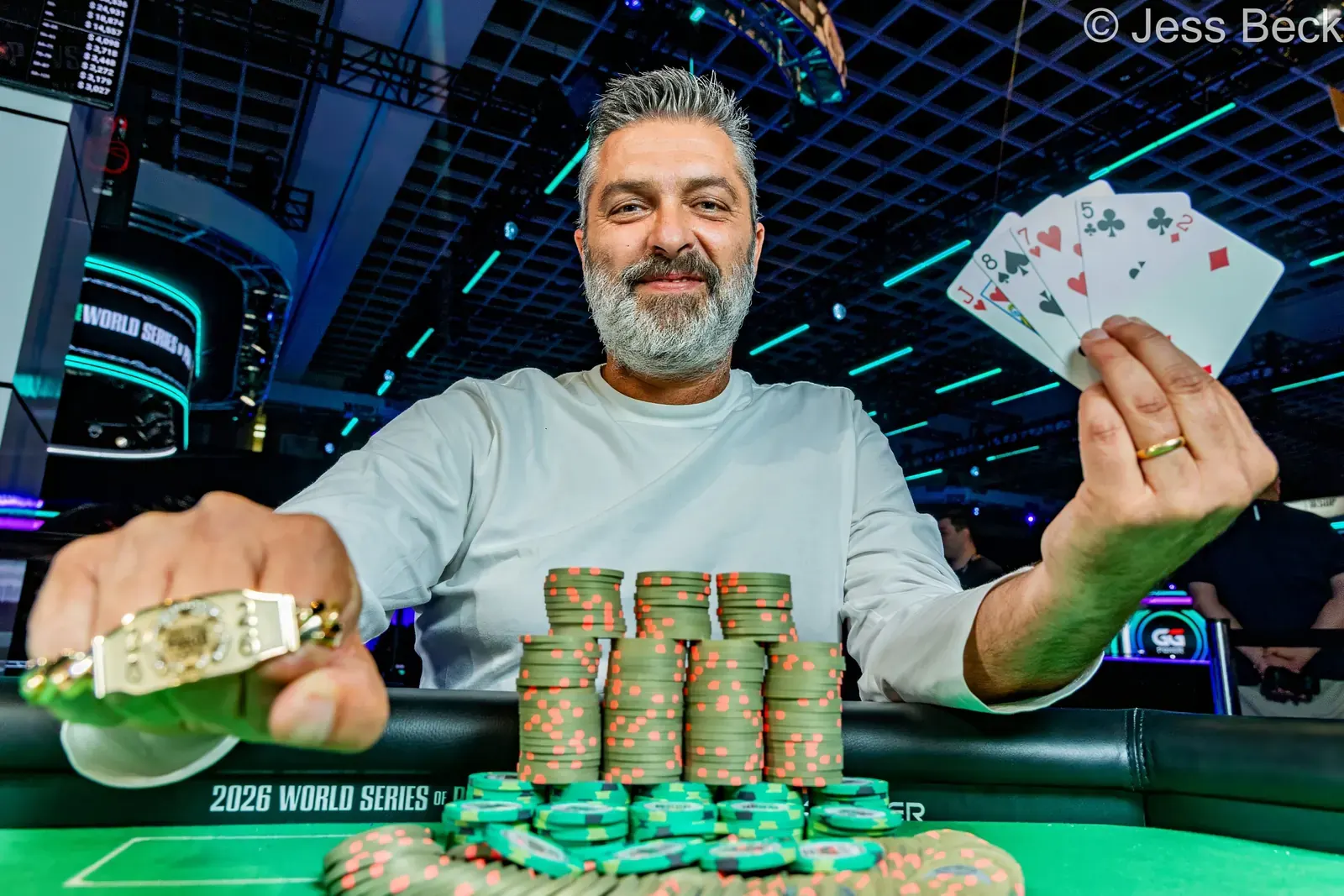 Sergio Benso smiles, holding a World Series of Poker gold bracelet after winning the Pick Your PLO tournament.