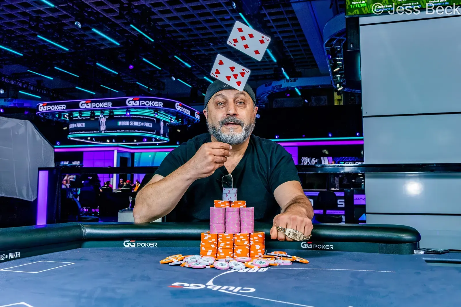 Johnny Oshana, winner of the WSOP Gladiators of Poker event, smiling and holding his gold bracelet.