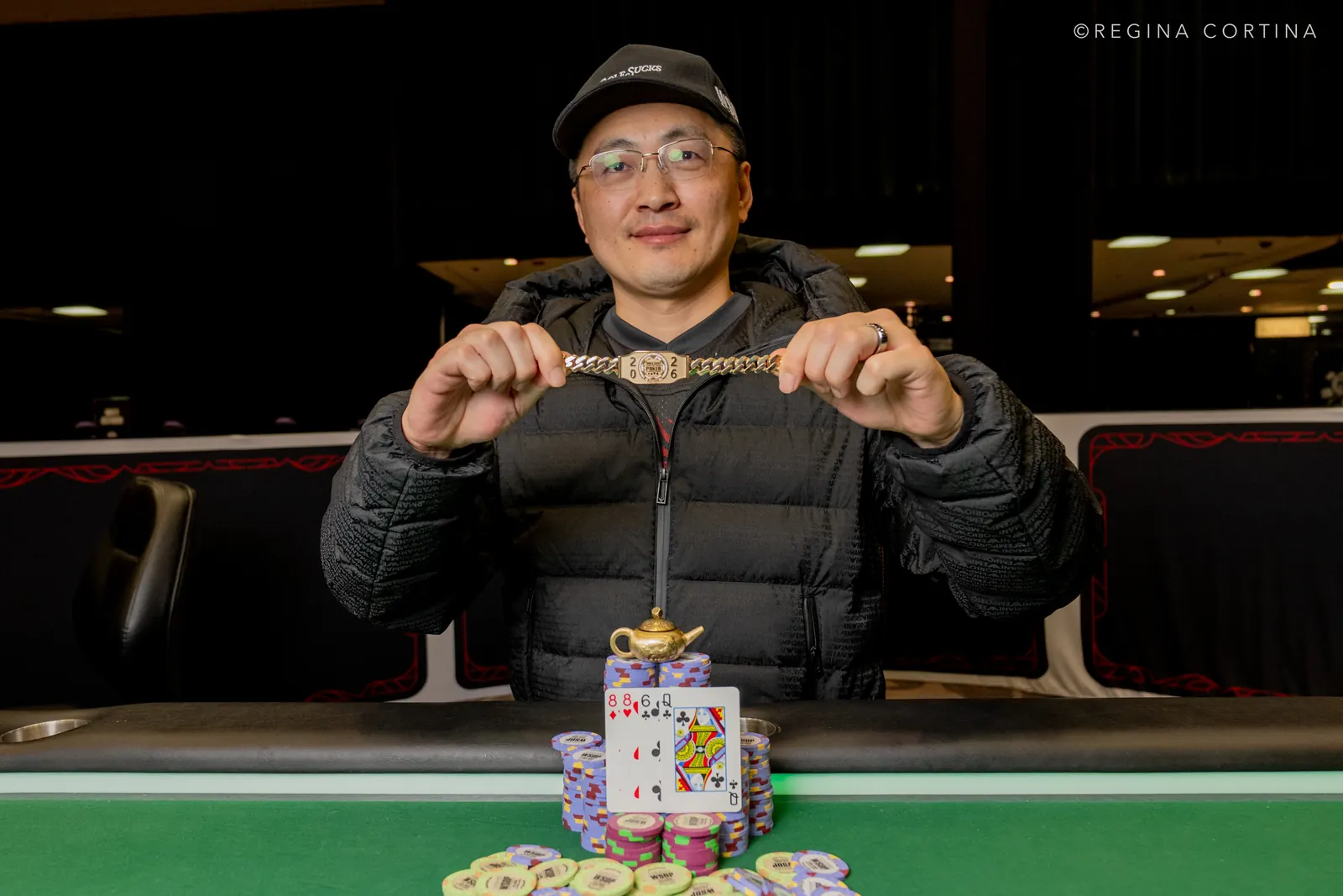 Joshua Wang holding his WSOP bracelet after winning the $3,000 6-Handed Pot-Limit Omaha event.