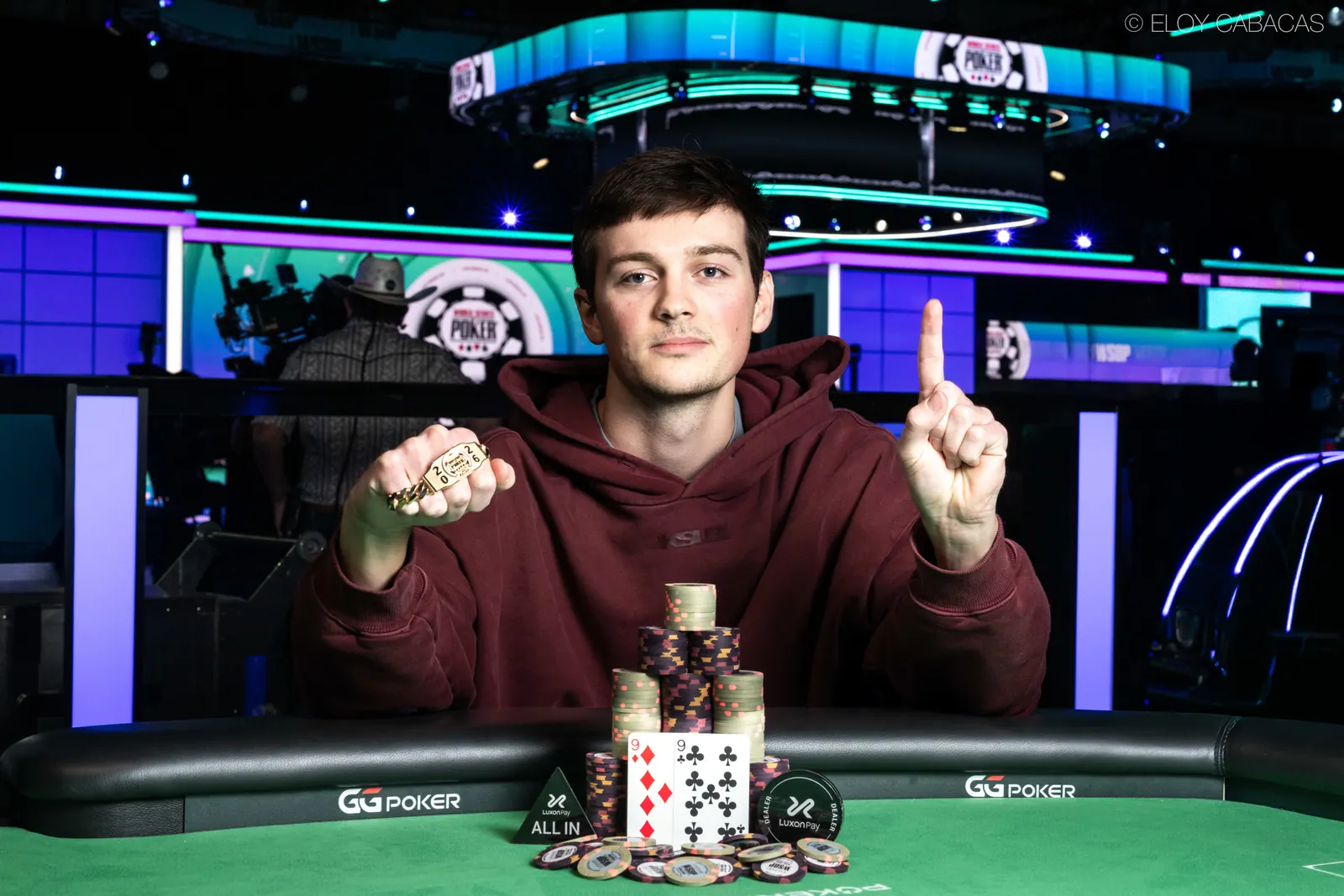 Myles Mullaly, winner of the WSOP $5,000 Super Turbo Bounty event, smiles with his trophy and chips.