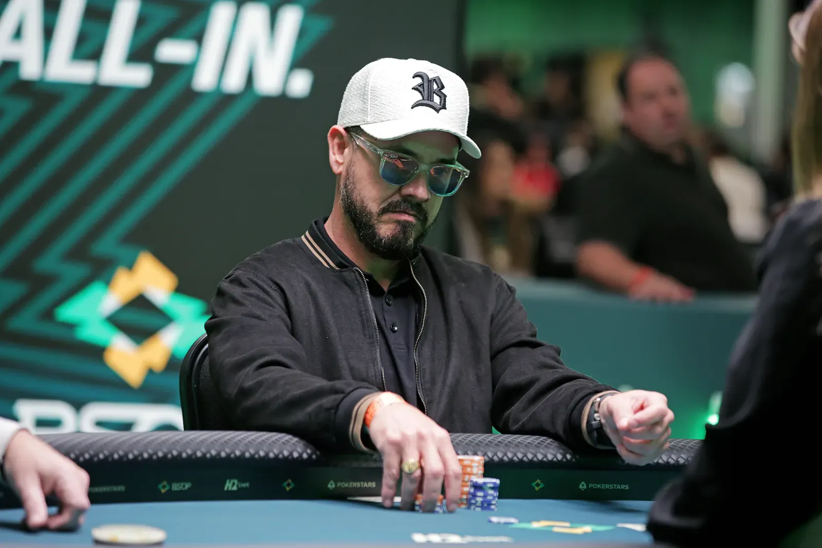 Alexandre Couto at the BSOP Winter Main Event final table, holding chips and smiling