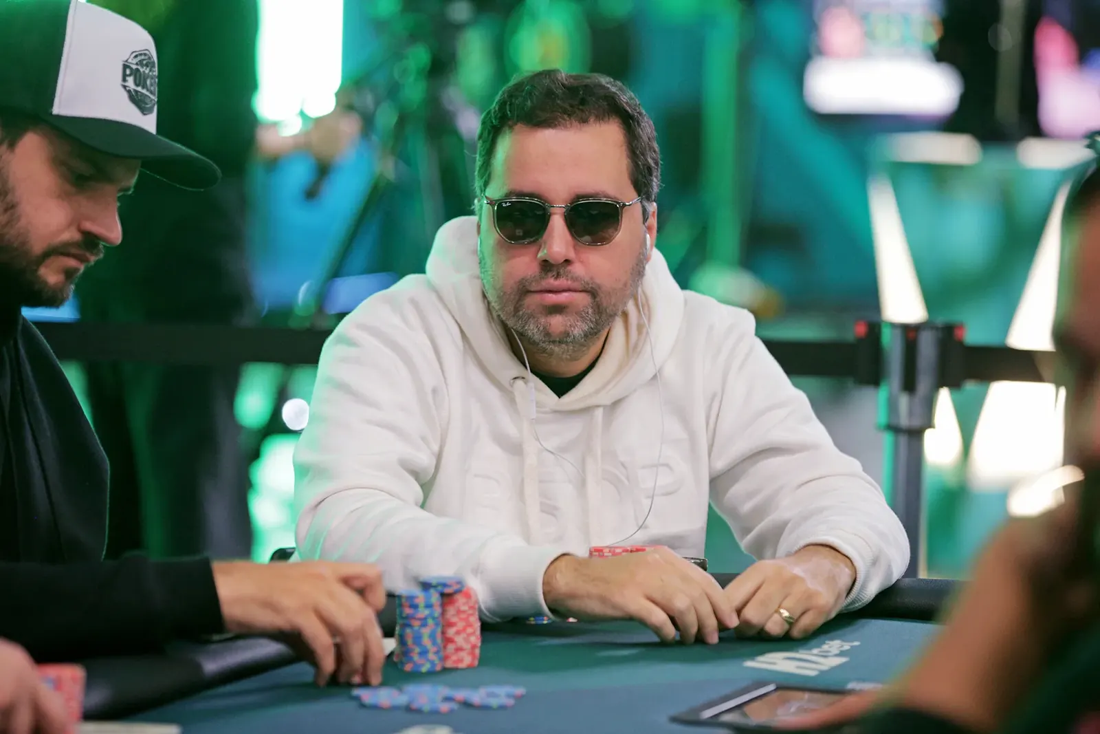 Nine players seated at the final table of the BSOP Winter Main Event, with chip stacks and a tournament clock in the background