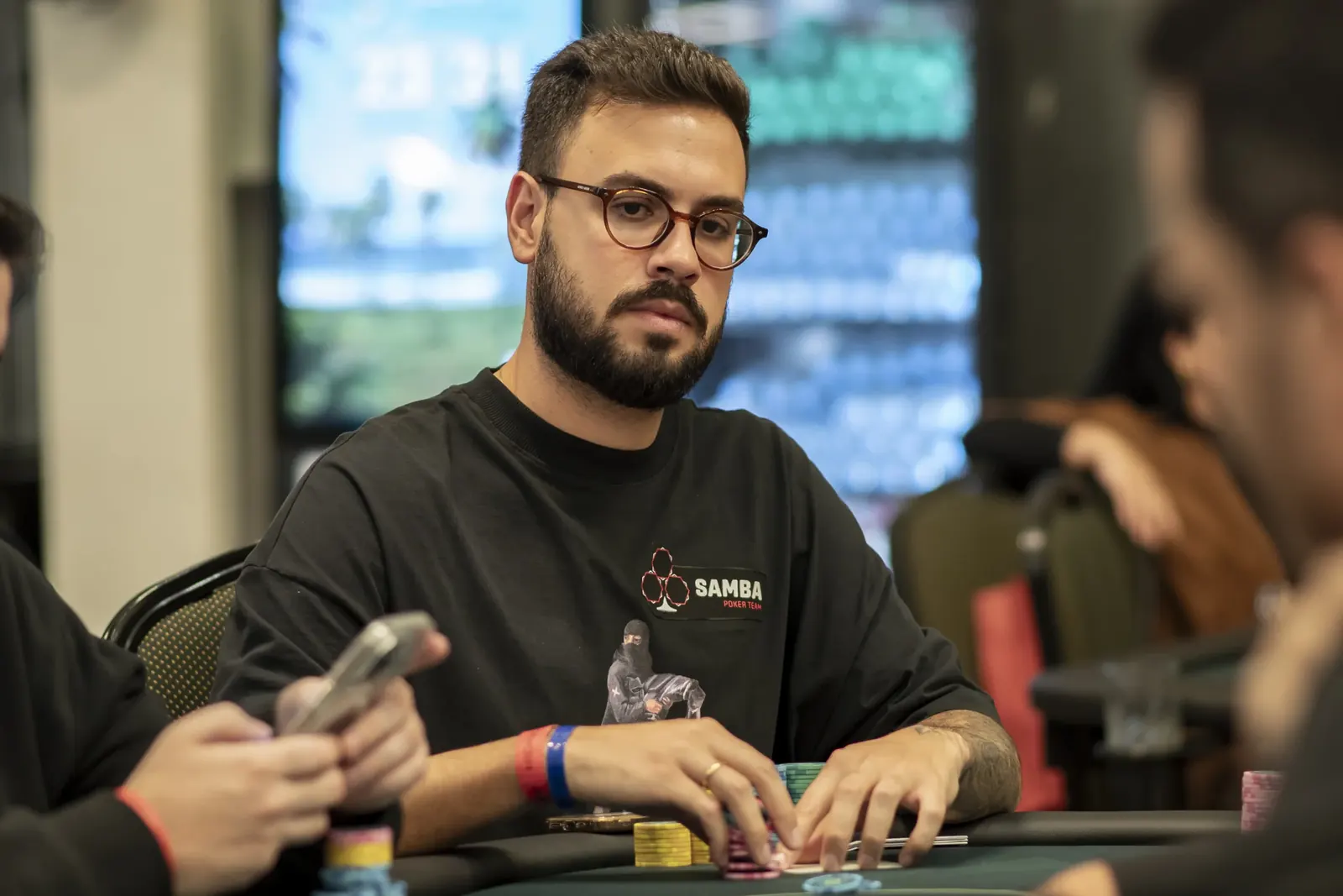 Tournament poker table during hand-for-hand bubble play, with chips and cards in the middle