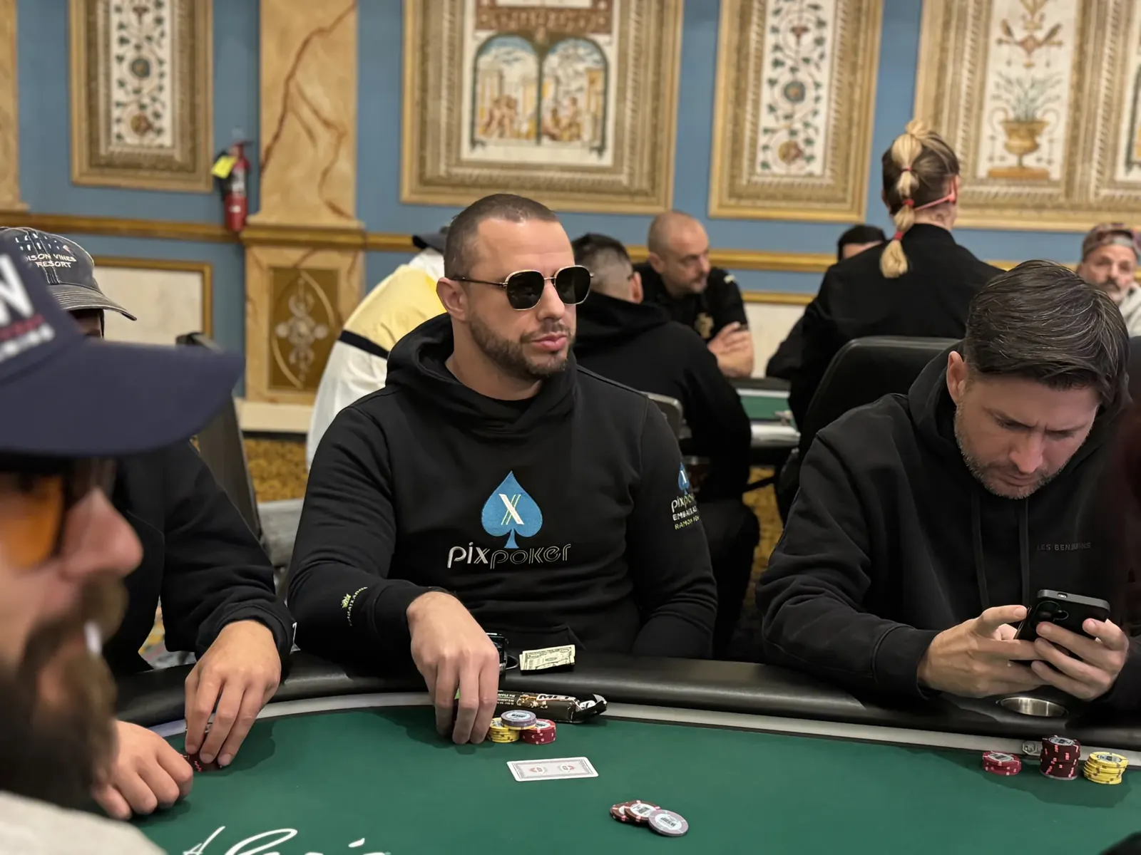 Players actively engaged at poker tables during the World Series of Poker Main Event.