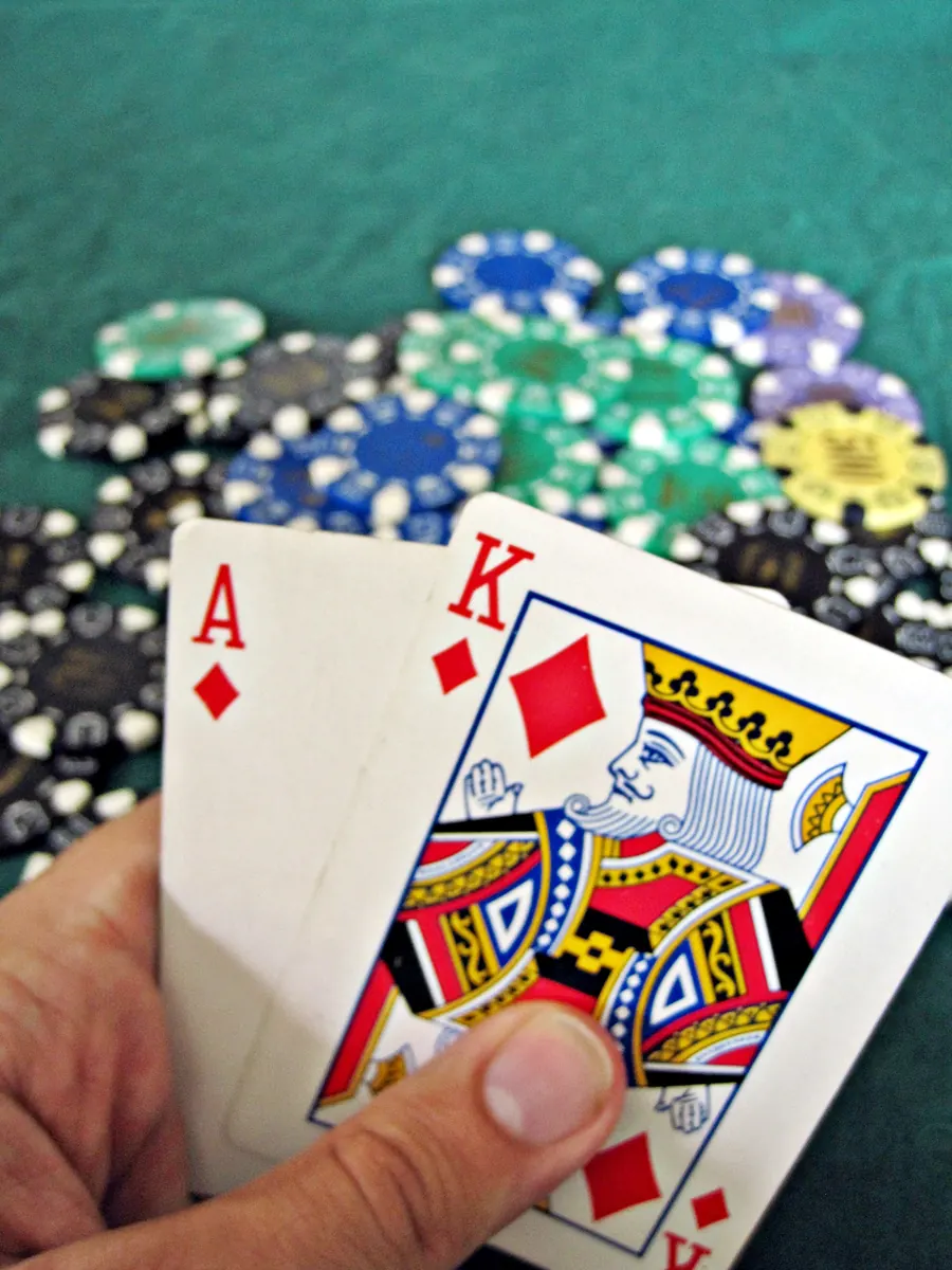 Screenshot of the "Video Poker Trainer" mobile app interface showing a dealt hand and strategy advice