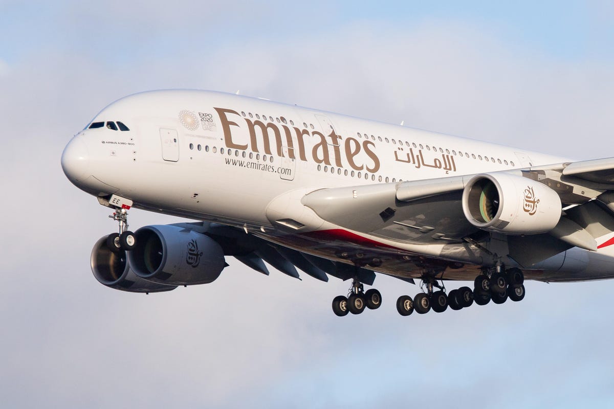 Emirates aircraft at Dubai International Airport with Crypto.com Pay digital payment option