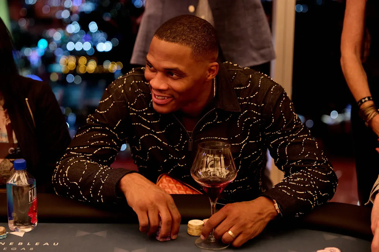Russell Westbrook and Phil Ivey seated at a poker table during the Why Not? Foundation charity poker event at Fontainebleau Las Vegas